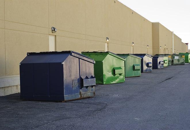 construction workers disposing of debris in large dumpsters in Highland